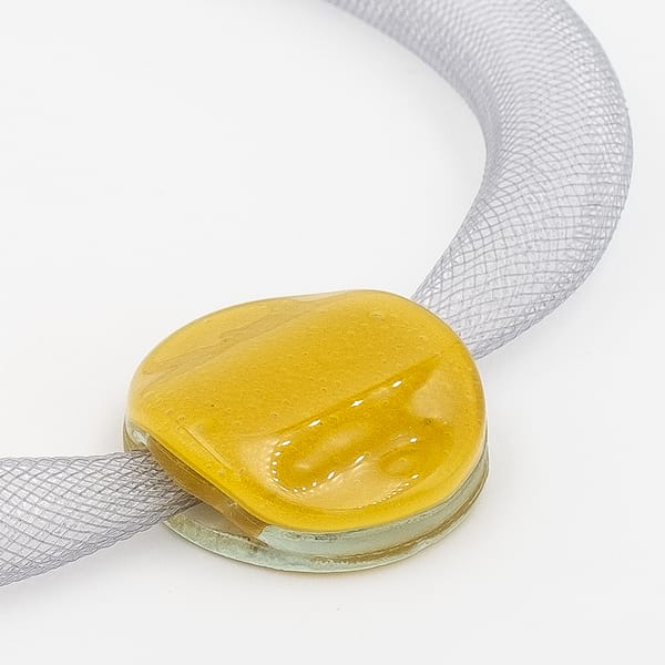 collar galatea con vidrio amarillo oscuro y malla clara visto en detalle